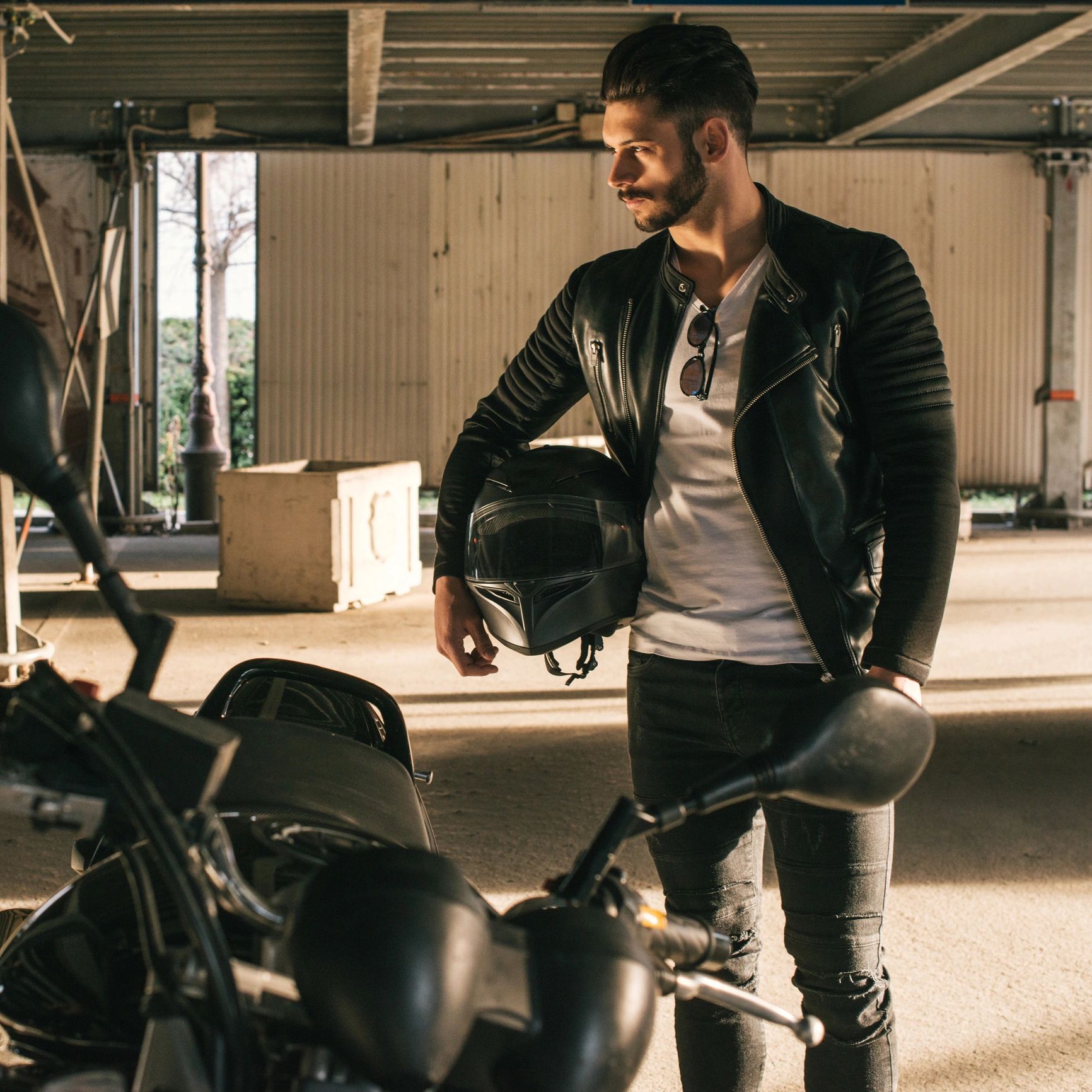 Motorcycle rider holding a helmet