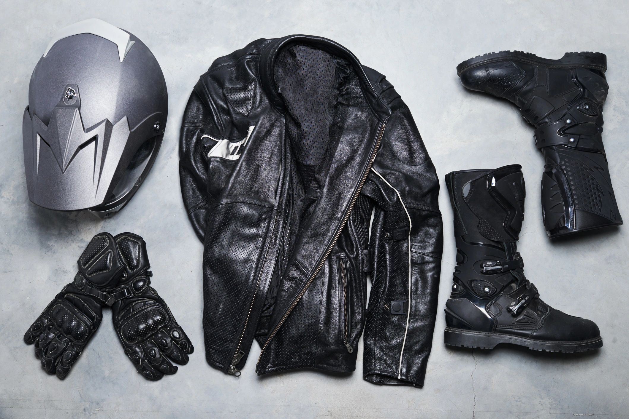Motorcycle gear laid out including helmet and gloves